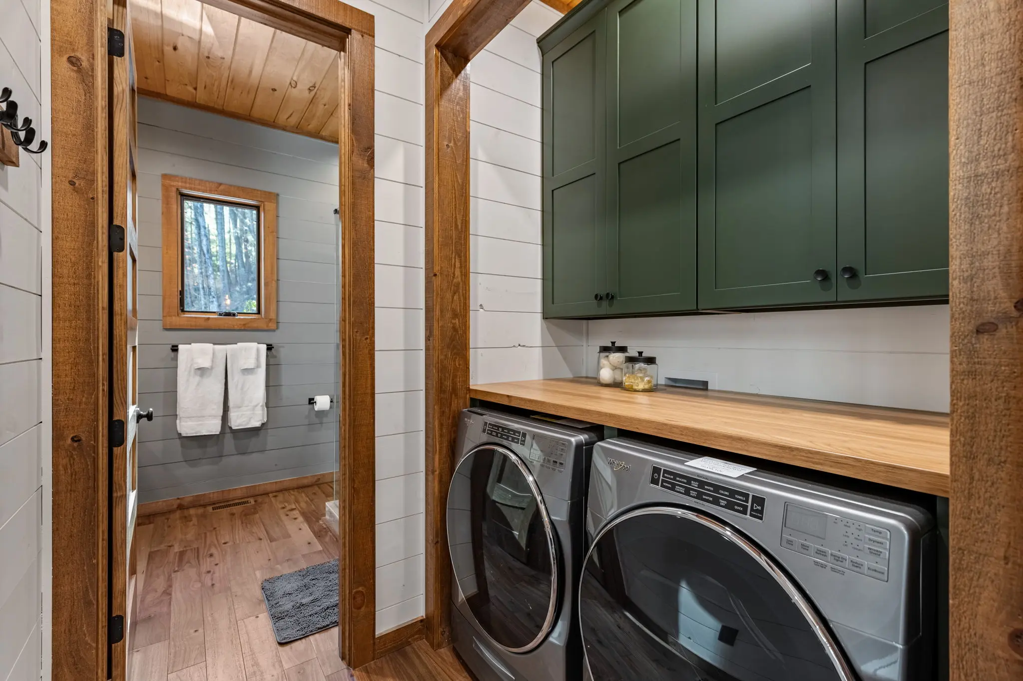 Laundry room with tons of hangers, ample storage and modern appliances.