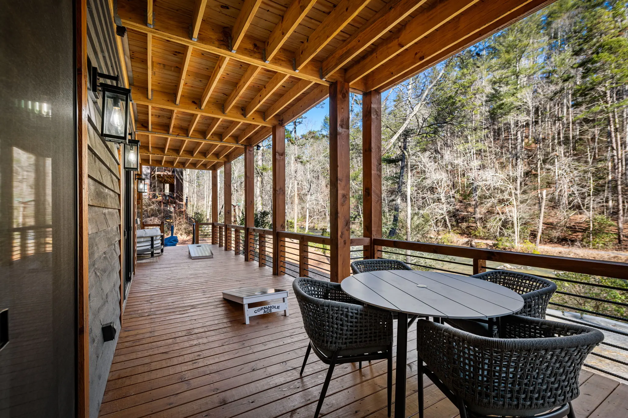 Lower balcony edge framing the surrounding forest and sky.