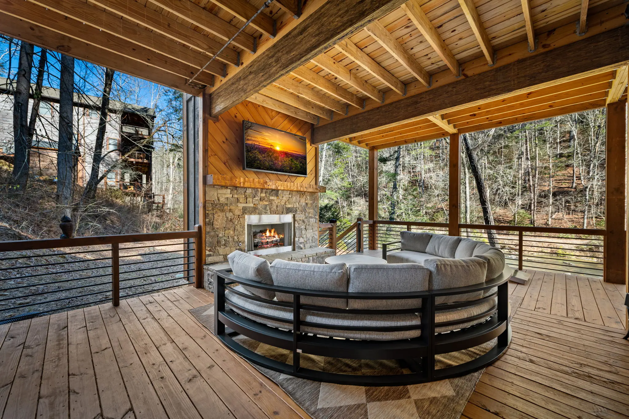 Wide lower-level balcony shot capturing outdoor ambience and greenery.